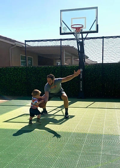 Father and son playing on Backyard Ballin' Custom Courts